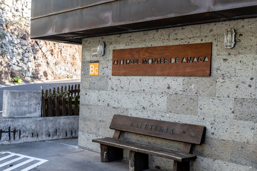 Ingresso Albergue Montes de Anaga con panchina e segnale Cafeteria.