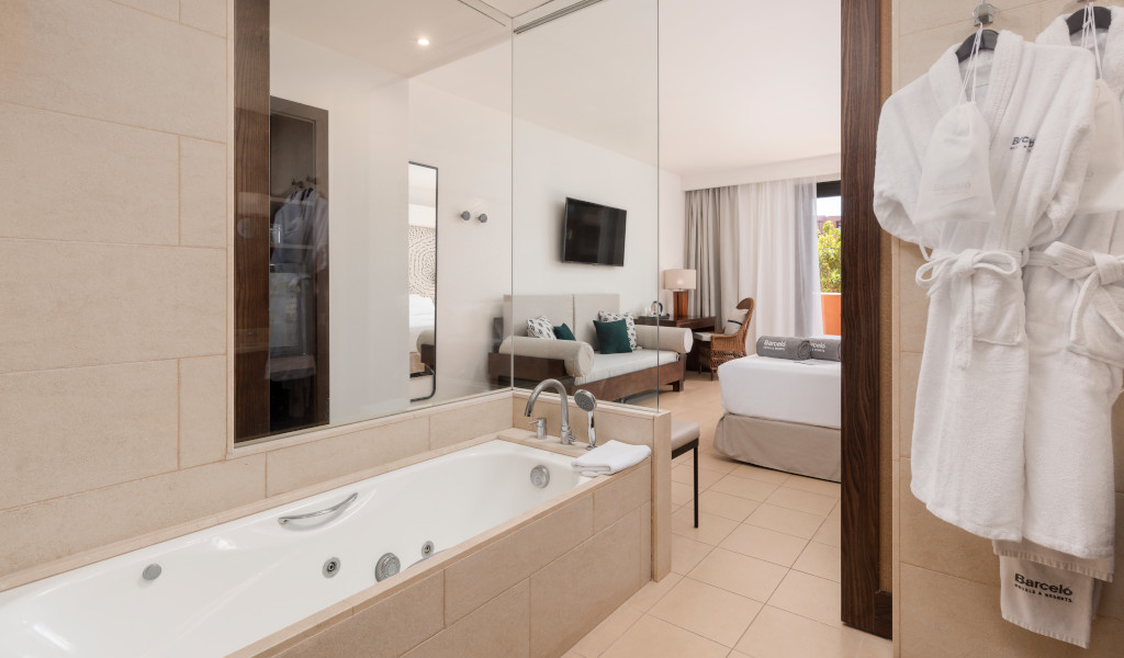 Bagno con vasca da bagno e vista sulla camera da letto di un hotel a Tenerife.