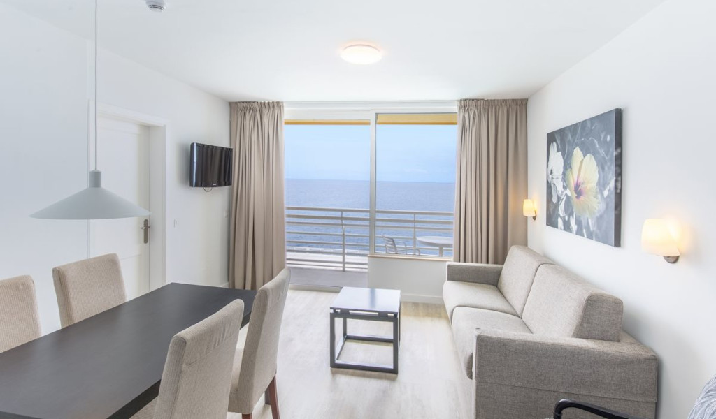 Soggiorno luminoso con divano, tavolo da pranzo e vista mare a Tenerife.