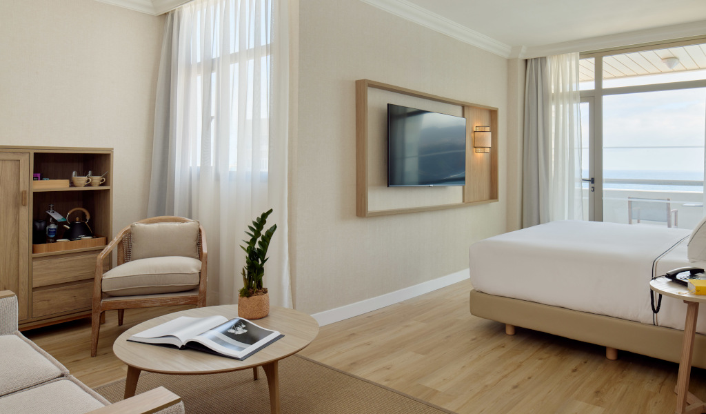 Camera d'albergo con letto matrimoniale, TV e vista mare a Tenerife.