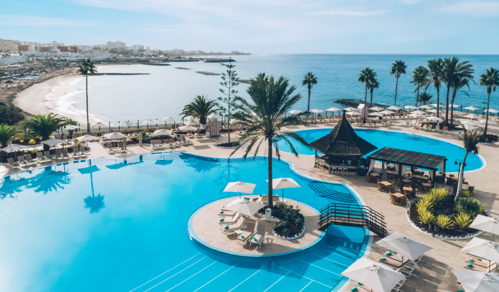 Piscina e palme con vista sull'oceano a Costa Adeje, Tenerife.