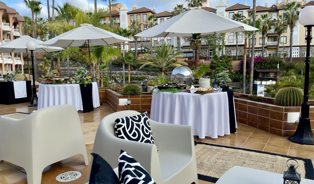 Terrazza con tavoli e ombrelloni in un resort a Costa Adeje, Tenerife.
