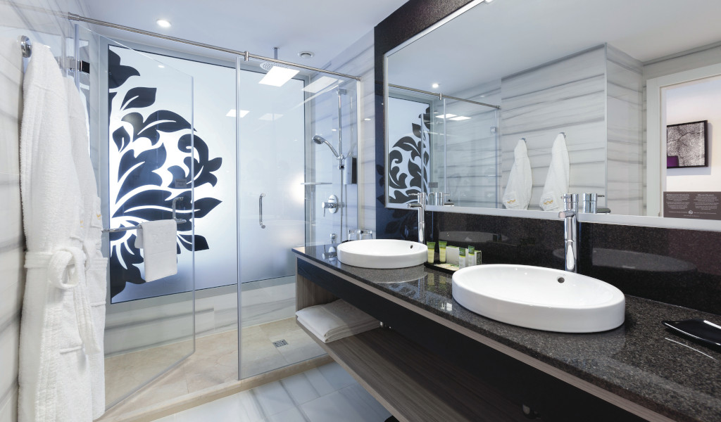 Bagno moderno con lavandini bianchi, specchio grande e doccia in hotel Tenerife.