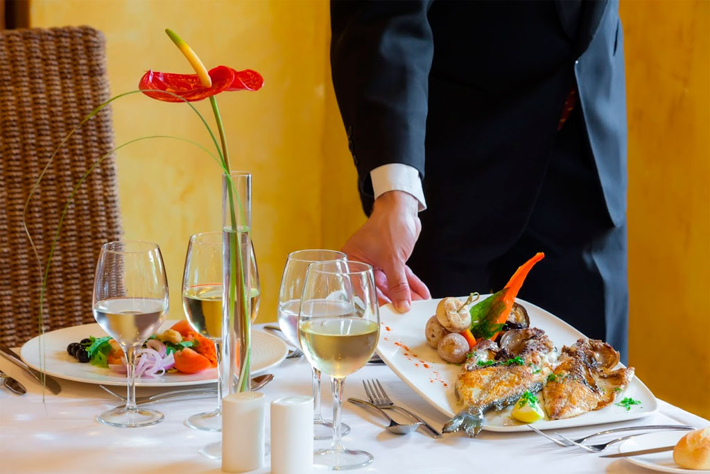 Servizio di piatti gourmet su tavolo elegante al ristorante, Tenerife.