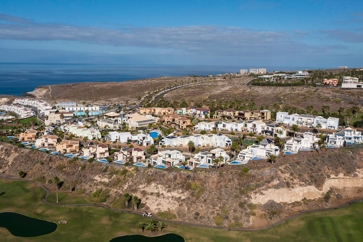 Complesso residenziale a Tenerife con piscine su una scogliera vicino al mare.