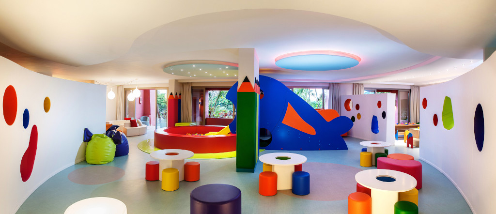 Area giochi per bambini con tavoli colorati e murales in una stanza a Tenerife.