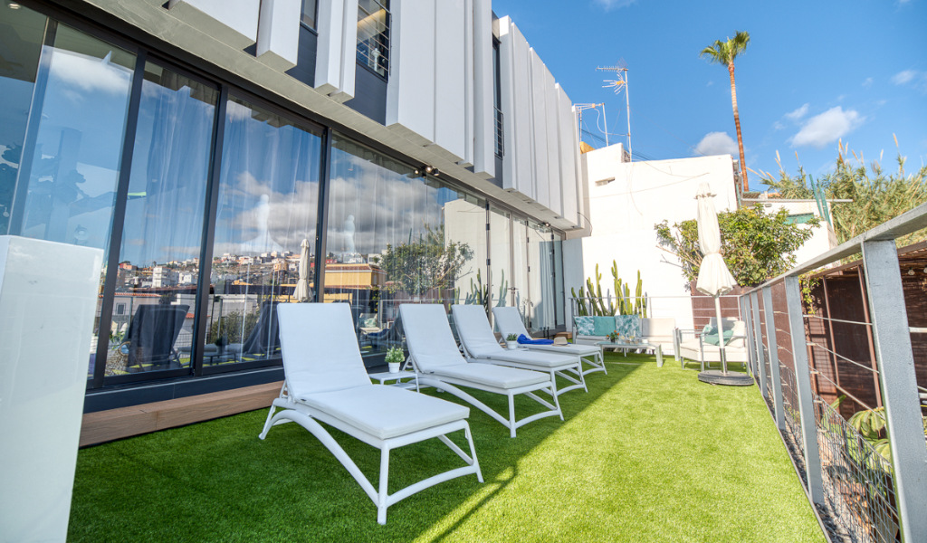 Sdraio bianche su prato verde in terrazza di hotel a Santa Cruz de Tenerife.
