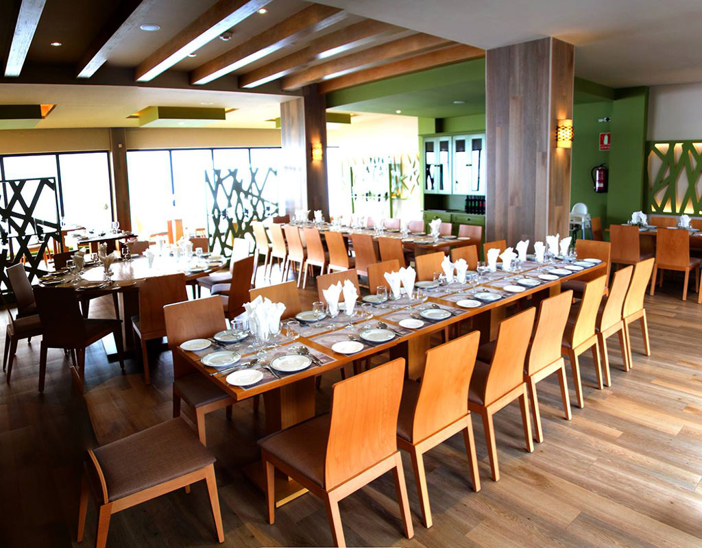 Elegante sala da pranzo con tavoli e sedie in legno preparati a Tenerife.
