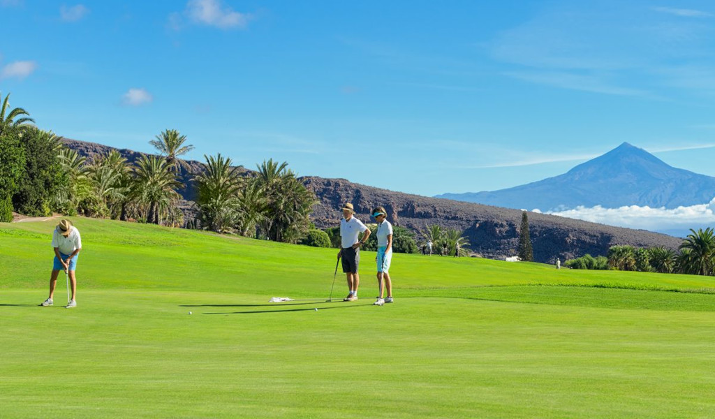 Golfisti su un campo a Tenerife con il Monte Teide sullo sfondo.