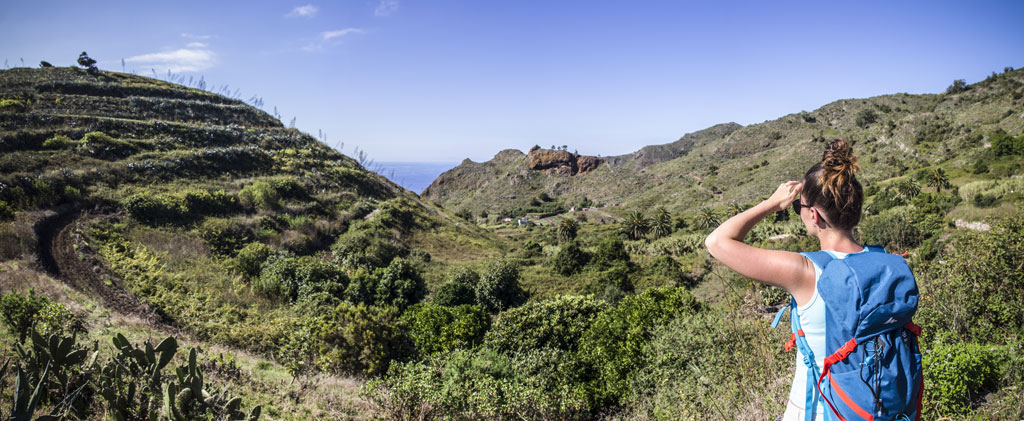 Persona con zaino osserva il paesaggio montuoso di Tenerife.