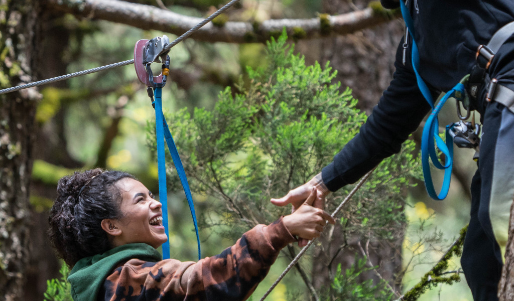 Persona che ride mentre fa ziplina in una foresta a Tenerife.