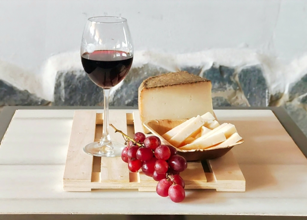 Bicchiere di vino rosso, formaggio e uva rossa su una tavola a Tenerife.
